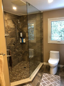 bathroom renovation showing glass enclosed shower and toilet